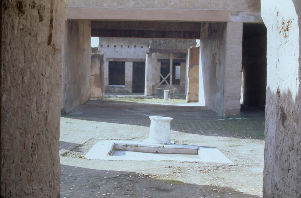 VI.13, Herculaneum. 4th December 1971. Looking south along entrance corridor towards atrium, and through to peristyle area.
Photo courtesy of Rick Bauer, from Dr George Fay’s slides collection.